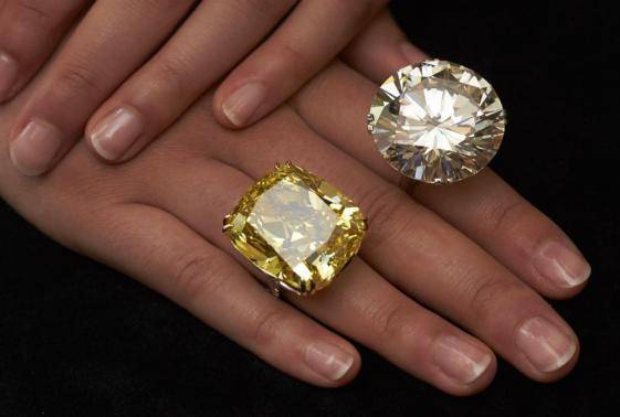 A model poses with a vivid yellow 100.09 carats diamond ...